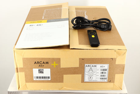 Box of a used Arcam A5+ Integrated Amplifier with mains cable, manual, and remote