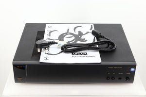 View of a used Arcam Alpha 10 Power Amplifier showing mains cable, and manual