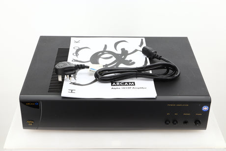 View of a used Arcam Alpha 10 Power Amplifier showing mains cable, and manual