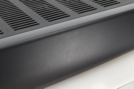 Close up view of a used Arcam Alpha 10 Power Amplifier showing scratching on the fascia