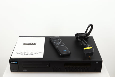Top of a used Arcam Alpha 5 Plus CD Player in a black finish showing Manual, Remote and Mains Cable
