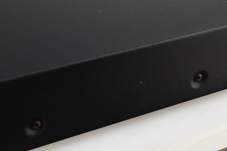 Close up of a used Arcam Alpha 5 Plus CD Player in a black finish showing tiny dink in cabinet on left side 