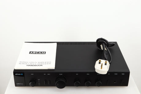 Top of a used Arcam Alpha 5 Plus Integrated Amplifier in a black finish showing Manual and Mains Cable