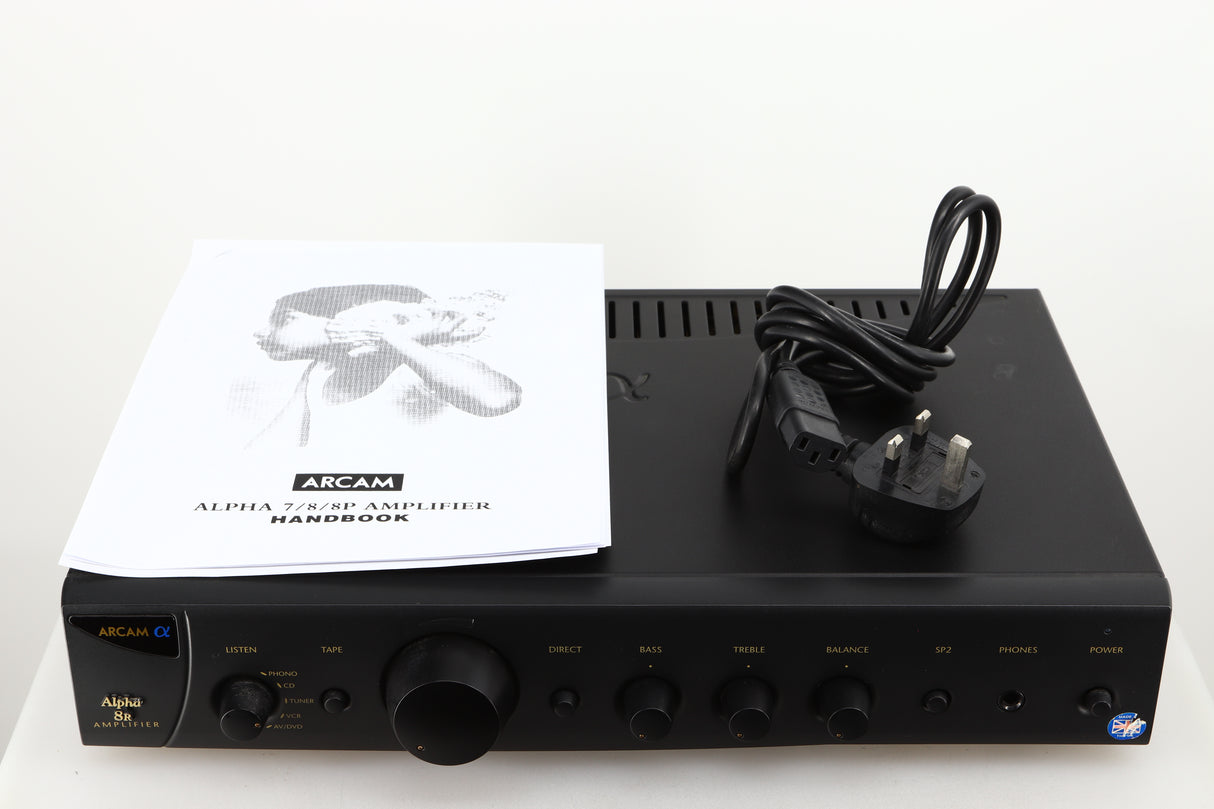 Top of a used Arcam Alpha 8R Integrated Amplifier in a black finish showing Manual and Mains Cable