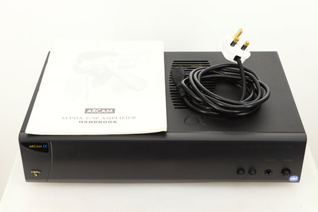 View of a used Arcam Alpha 9 Power Amplifier showing mains cable, and manual