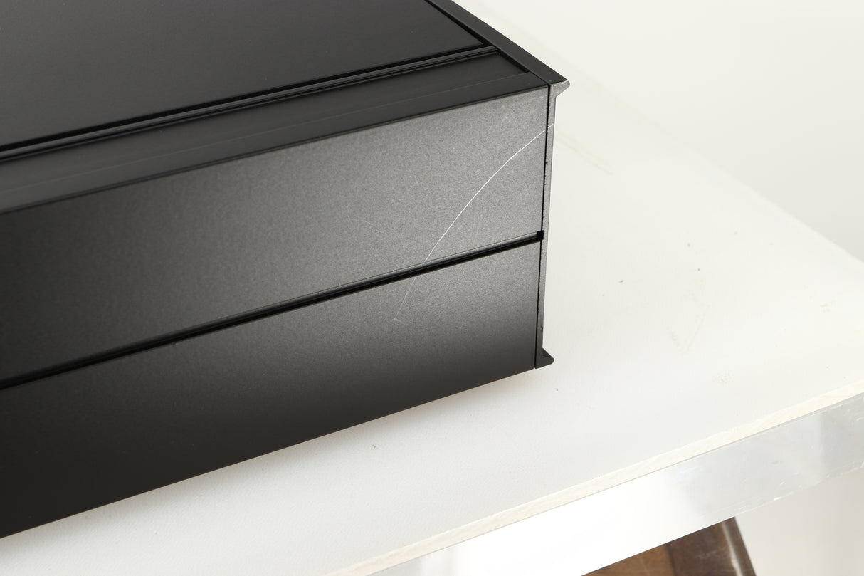 Close up view of a used Arcam Alpha II AM/FM Tuner showing a scratch on the back left corner