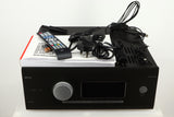 Top of a used Arcam AVR30 AV Amplifier in a grey finish showing Mains Cable, Schuko Cable, USB Cable, Manual, Remote, 2x Batteries, 2x Wi-Fi Aerials, Bluetooth Aerial, Set-Up MIC and Adaptor