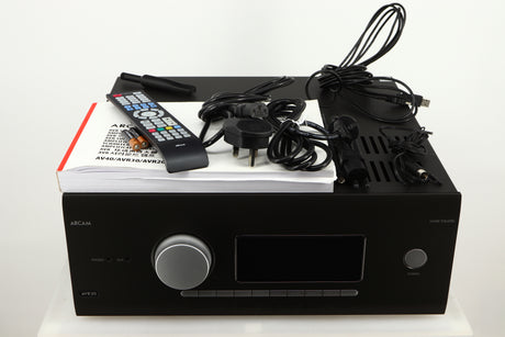 Top of a used Arcam AVR30 AV Amplifier in a grey finish showing Mains Cable, Schuko Cable, USB Cable, Manual, Remote, 2x Batteries, 2x Wi-Fi Aerials, Bluetooth Aerial, Set-Up MIC and Adaptor