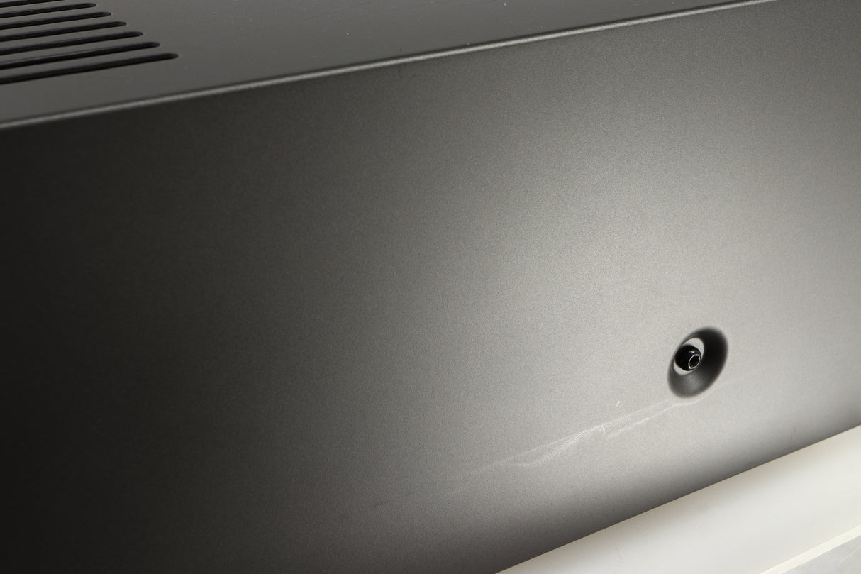 Close up of a used Arcam AVR30 AV Amplifier in a grey finish showing some scratching on right side 
