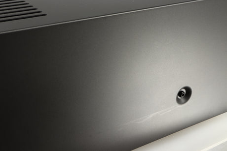 Close up of a used Arcam AVR30 AV Amplifier in a grey finish showing some scratching on right side 