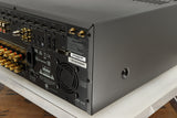 Rear left corner of a used Arcam AVR30 AV Amplifier in a grey finish