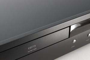 Close up view of a used Arcam CD73T CD Player in Black finish showing some small dents and scratches on the front edge