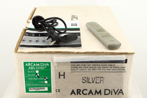 Box for a used Arcam Diva A85 Integrated Amplifier in a silver finish showing Manual, Mains Cable and Remote