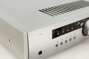 Close up of a used Arcam Diva A85 Integrated Amplifier in a silver finish showing some scratching on the fascia