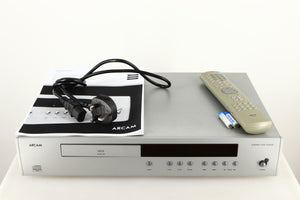 Top of a used Arcam Diva CD72 CD Player in a silver finish showing Mains Cable, Remote, Batteries and Manual