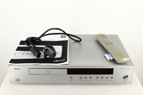 Top of a used Arcam Diva CD72 CD Player in a silver finish showing Mains Cable, Remote, Batteries and Manual