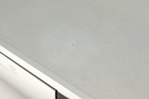 Close up of a used Arcam Diva CD72 CD Player in a silver finish showing mark on top