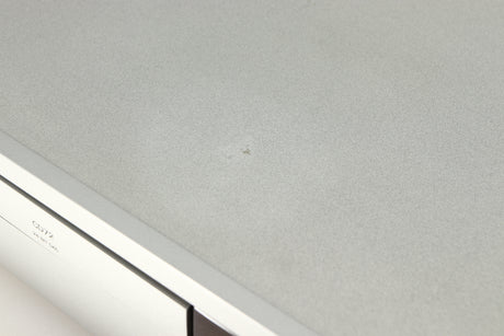 Close up of a used Arcam Diva CD72 CD Player in a silver finish showing mark on top