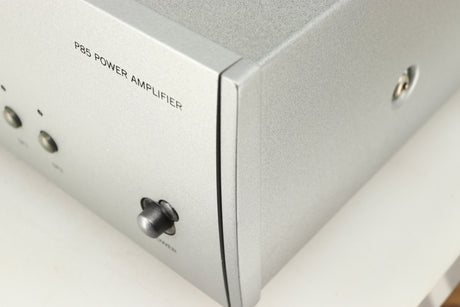 Close up of a used Arcam P85/3 Power Amplifier in a silver finish showing scratch on fascia