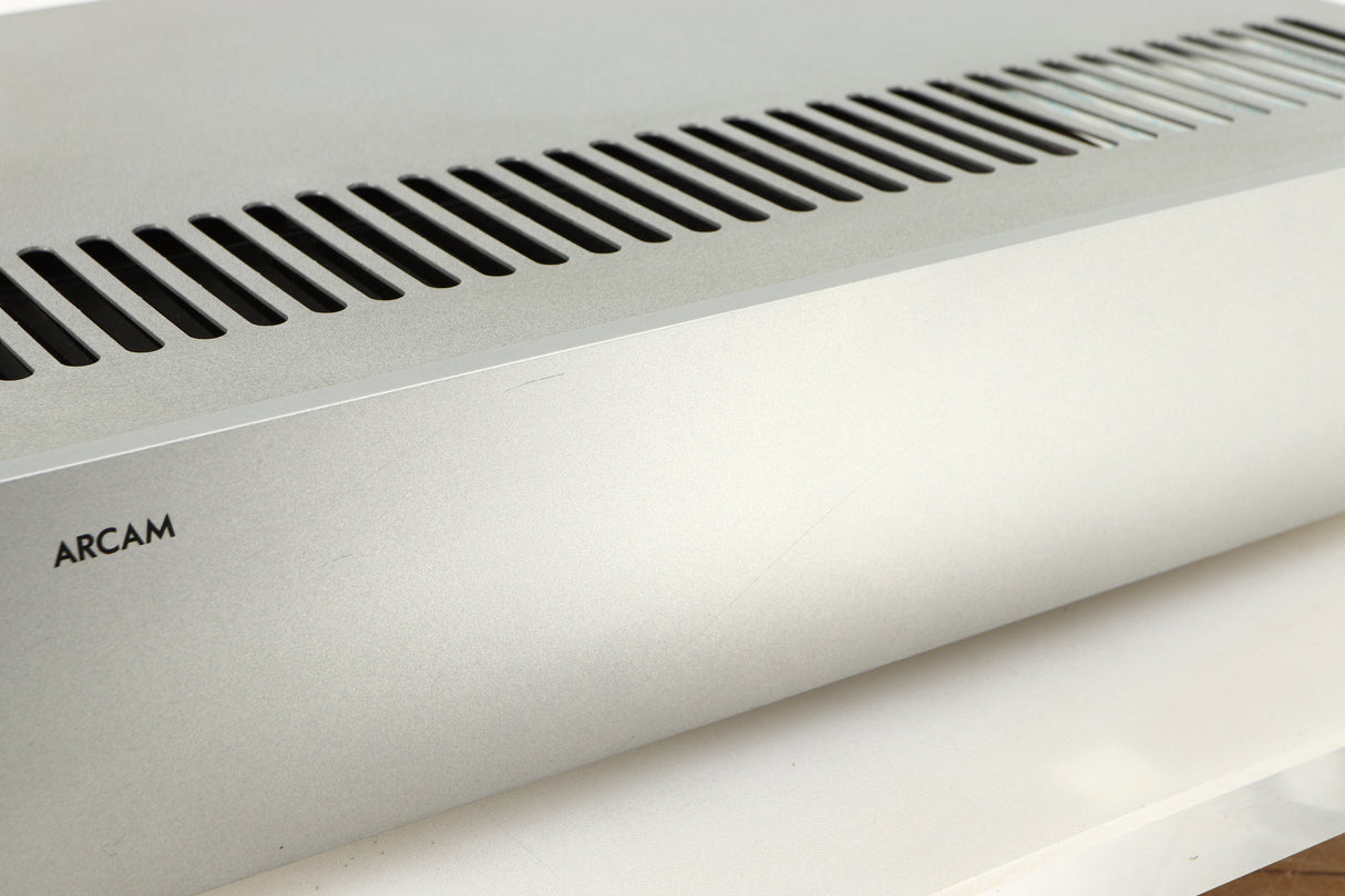 Close up of a used Arcam P85/3 Power Amplifier in a silver finish showing scratches on fascia