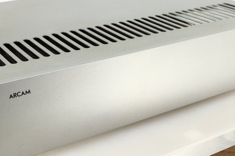 Close up of a used Arcam P85/3 Power Amplifier in a silver finish showing scratches on fascia