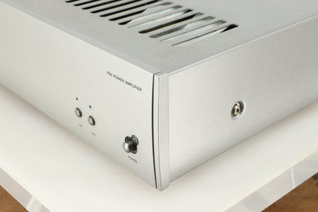Front right corner of a used Arcam P85/3 Power Amplifier in a silver finish