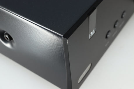 Close up of a used Arcam FMJ A19 Integrated Amplifier in a black finish showing light scratch on front left corner 