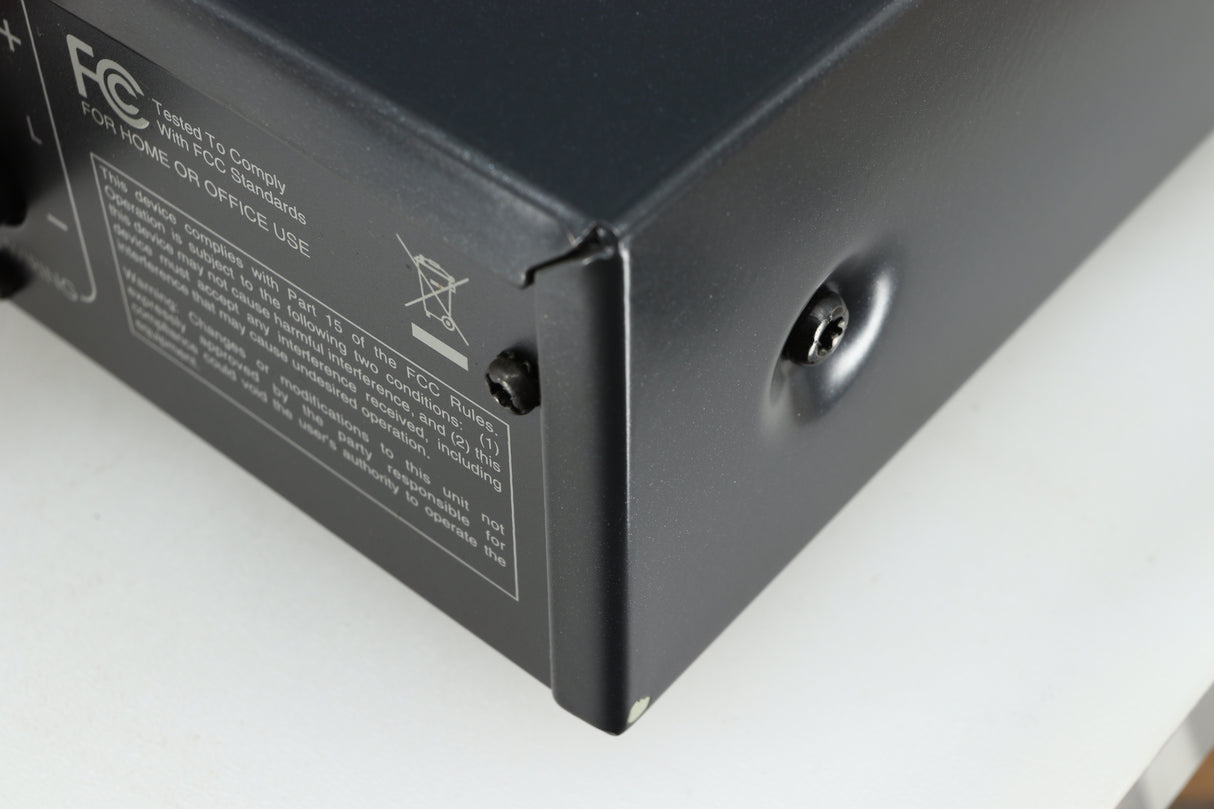Close up of a used Arcam FMJ A19 Integrated Amplifier in a black finish showing small blemish