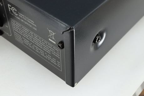 Close up of a used Arcam FMJ A19 Integrated Amplifier in a black finish showing small blemish