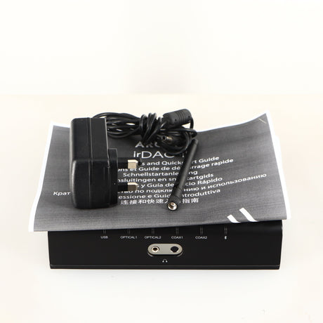 Top of a used Arcam ir-DAC-II Digital Analogue Converter in a black finish showing PSU, Manual and Antenna