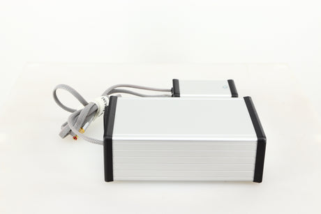 Left side view of a used MCRU Power Supply in a silver finish