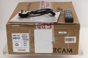 Box of a used Arcam SA20 Integrated Amplifier with mains cable, manual, and remote