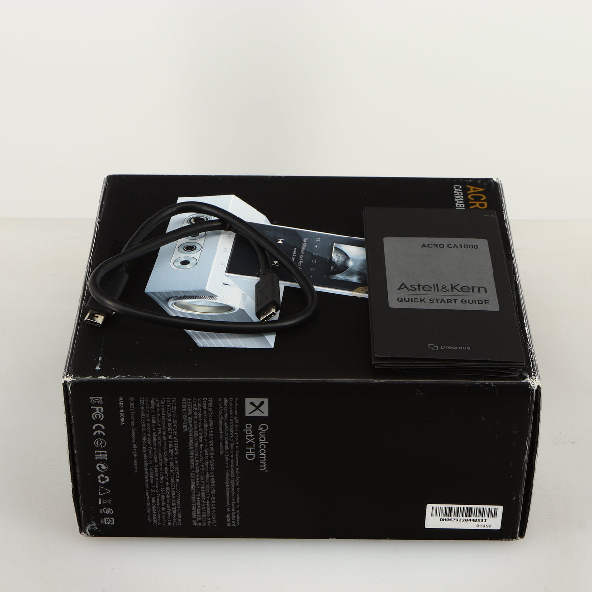 Box for a used Astrell & Kern Acro CA1000 Headphone Amplifier in a silver finish showing Manual and USB Cable