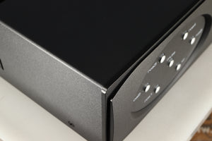 Close up of a used Astin Trew AT2-2100 Integrated Amplifier in a black finish showing very minor graze on front left corner