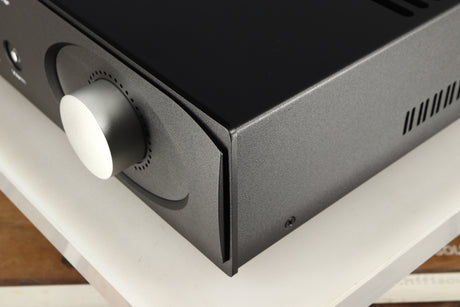 Front right corner of a used Astin Trew AT2-2100 Integrated Amplifier in a black finish