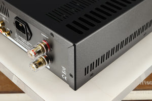 Rear left corner of a used Astin Trew AT2-2100 Integrated Amplifier in a black finish