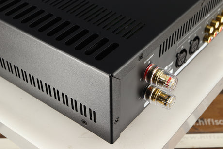 Rear right corner of a used Astin Trew AT2-2100 Integrated Amplifier in a black finish
