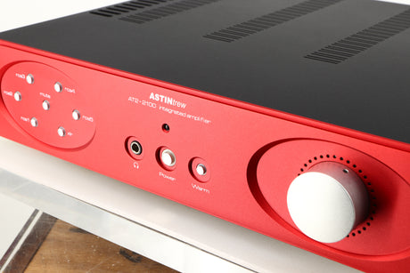 Close up of a used Astin Trew AT2-2100 Integrated Amplifier in a red finish showing some of the fascia