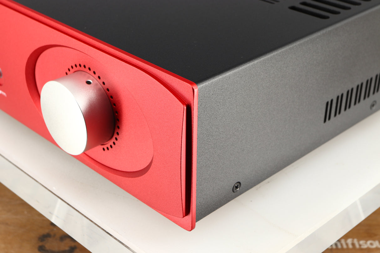 Front right corner of a used Astin Trew AT2-2100 Integrated Amplifier in a red finish