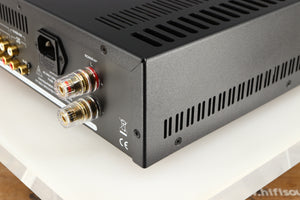 Rear left corner of a used Astin Trew AT2-2100 Integrated Amplifier in a red finish