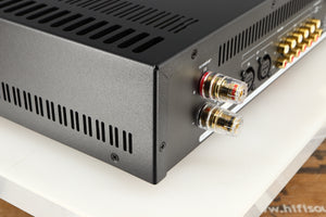 Rear right corner of a used Astin Trew AT2-2100 Integrated Amplifier in a red finish