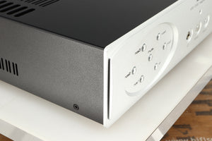 Front left corner of a used Astin Trew AT2-2100 Integrated Amplifier in a silver finish