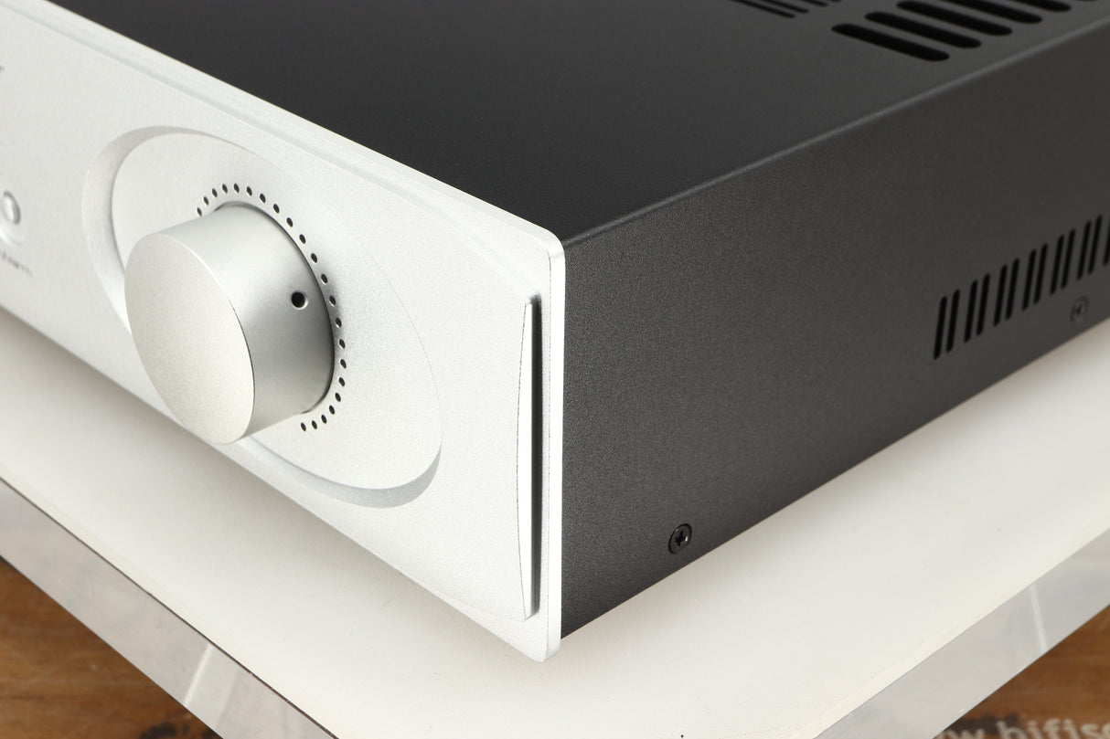 Front right corner of a used Astin Trew AT2-2100 Integrated Amplifier in a silver finish
