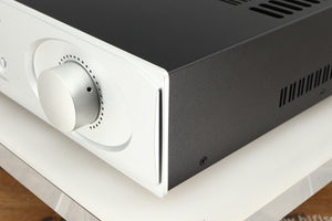 Front right corner of a used Astin Trew AT2-2100 Integrated Amplifier in a silver finish