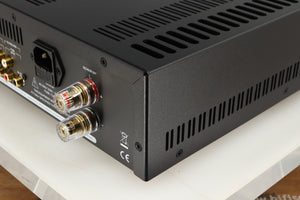 Rear left corner of a used Astin Trew AT2-2100 Integrated Amplifier in a silver finish