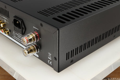 Rear left corner of a used Astin Trew AT2-2100 Integrated Amplifier in a silver finish