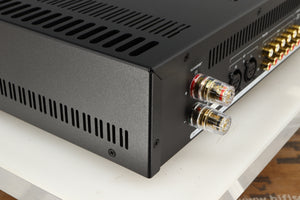 Rear right corner of a used Astin Trew AT2-2100 Integrated Amplifier in a silver finish