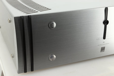 Close up view of a used ATC P1 Power Amplifier in silver finish showing the left side of the fascia