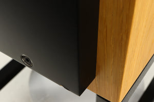 Close up of a used ATC SCM50SL Active Classic Standmount Speaker in a oak finish showing small blemish on fascia