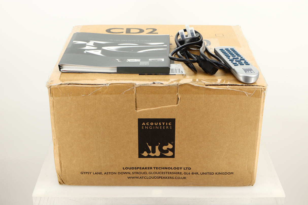 Box of a used ATC SIA2-100 Integrated Amplifier in Silver finish showing mains cable, manual, and remote